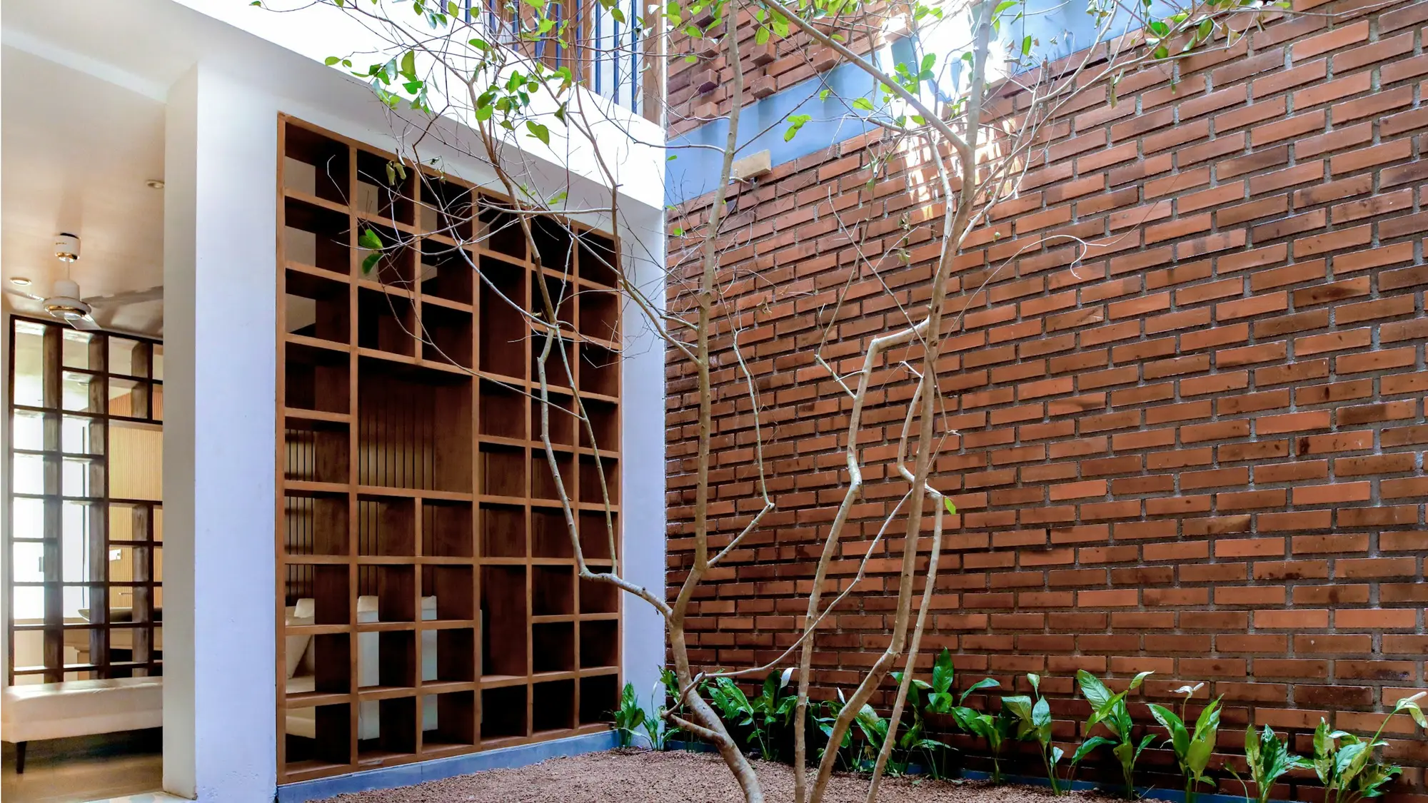 Timber shelving set into a brick wall