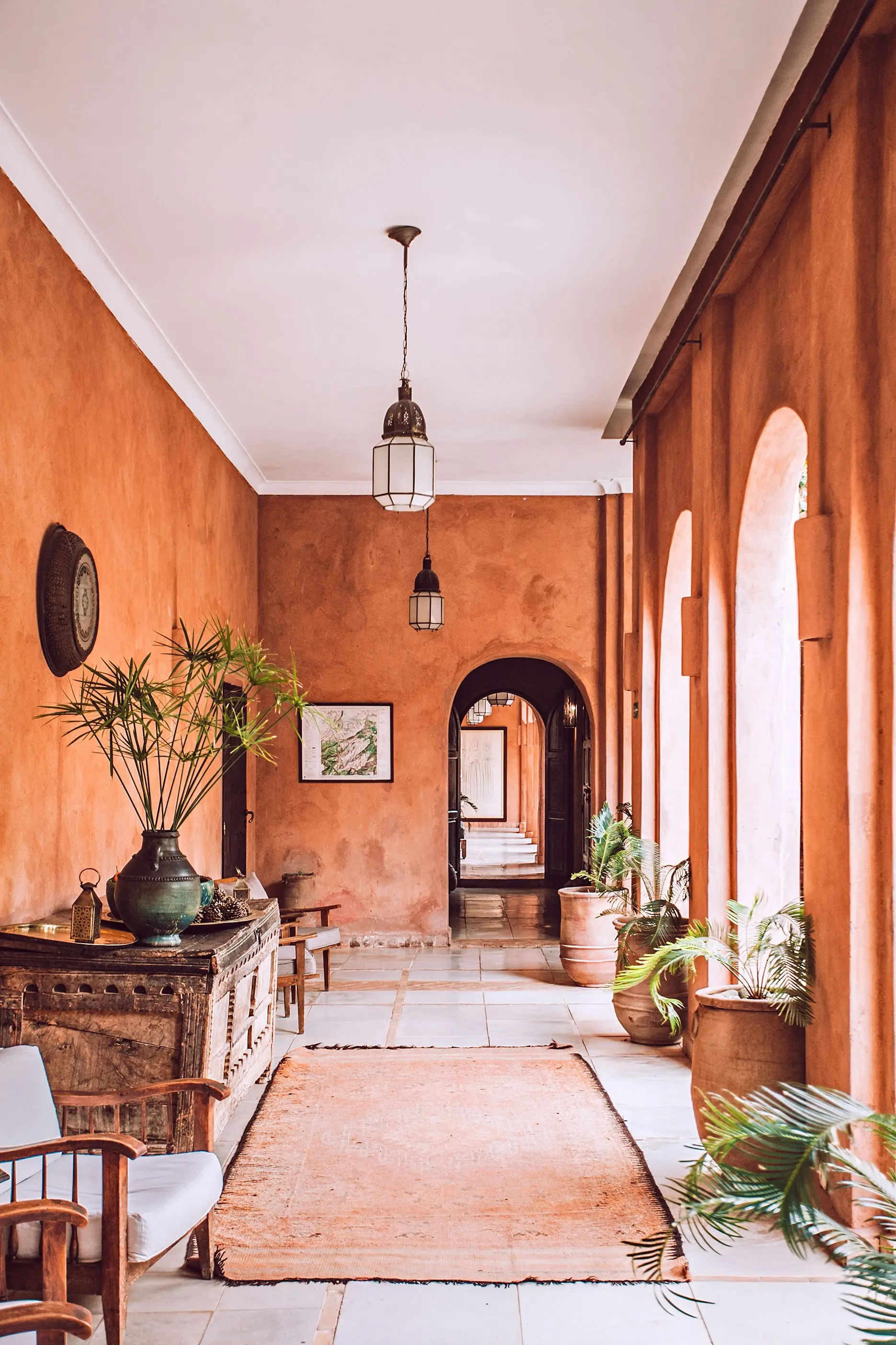Terracotta walls and arches along a courtyard